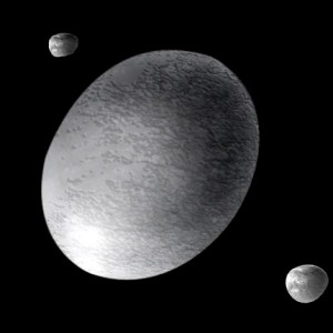 Recreación de Haumea (un planeta enano) y sus dos satélites. Crédito: A. Feild (Space Telescope Science Institute)