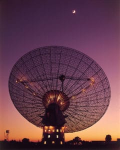 El radiotelescopio Parkes, con la Luna al fondo, en 1969, cuando recibió las señales del aterrizaje del Apolo 11 en nuestro satélite. Crédito: CSIRO