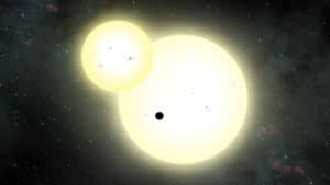El planeta circumbinario Kepler-1647b (el punto negro) transitando delante de sus estrellas. Crédito: Lynette Cook